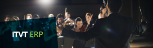 Ein Dirigent steht vor dem Publikum, den Taktstock in der Hand, und leitet leidenschaftlich das Orchester.