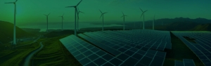 Solarpanels im Vordergrund, Windkraftanlagen im Hintergrund vor einem klaren, sonnigen Himmel