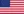 Eine kleine rechteckige Flagge mit horizontalen roten und weiÃŸen Streifen und einem blauen Quadrat in der oberen linken Ecke, das weiÃŸe Sterne enthÃ¤lt. Sie stellt ein Symbol dar, das hÃ¤ufig mit den USA in Verbindung gebracht wird.